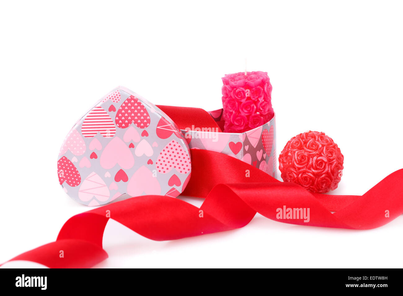 Red ribbon, candles and gift box isolated on white background Stock