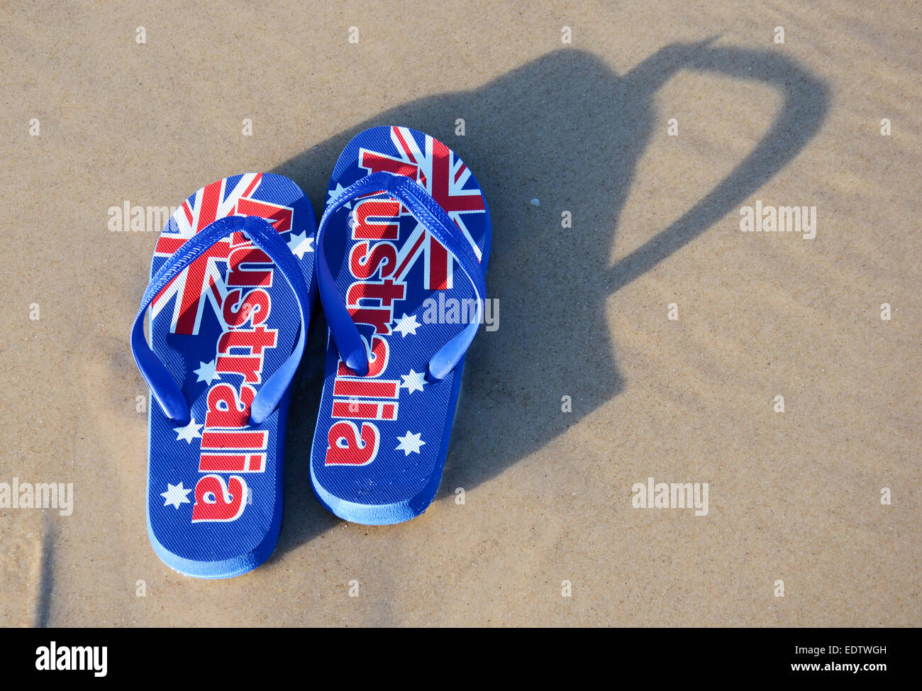 Australian sandals flip flops thongs with Australian flag on wide sandy  beach in early morning sun. Taken in South Australia Stock Photo - Alamy