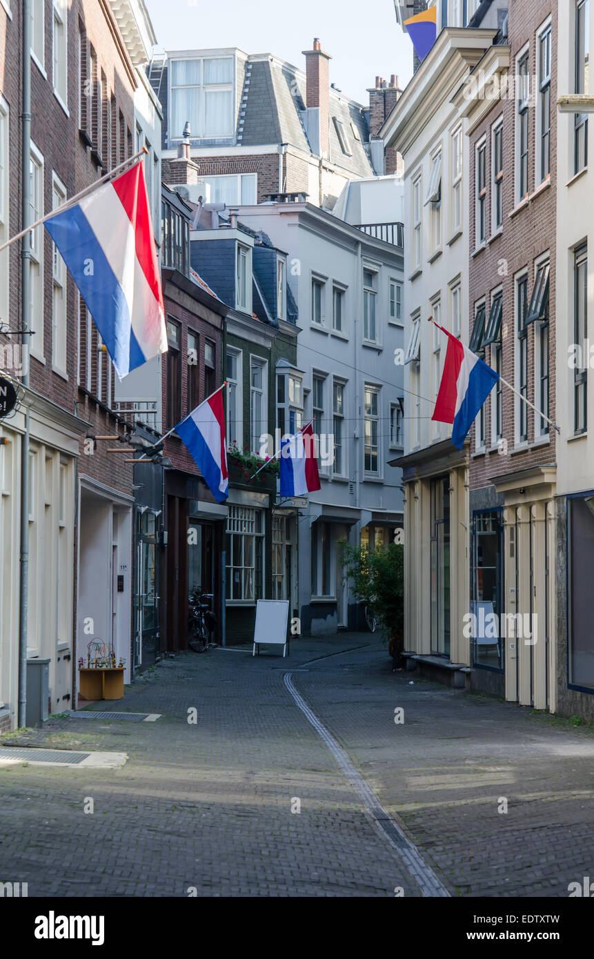 The day after the government opens in The Hague, Netherlands, Dutch flags hang along a quiet city street Stock Photo