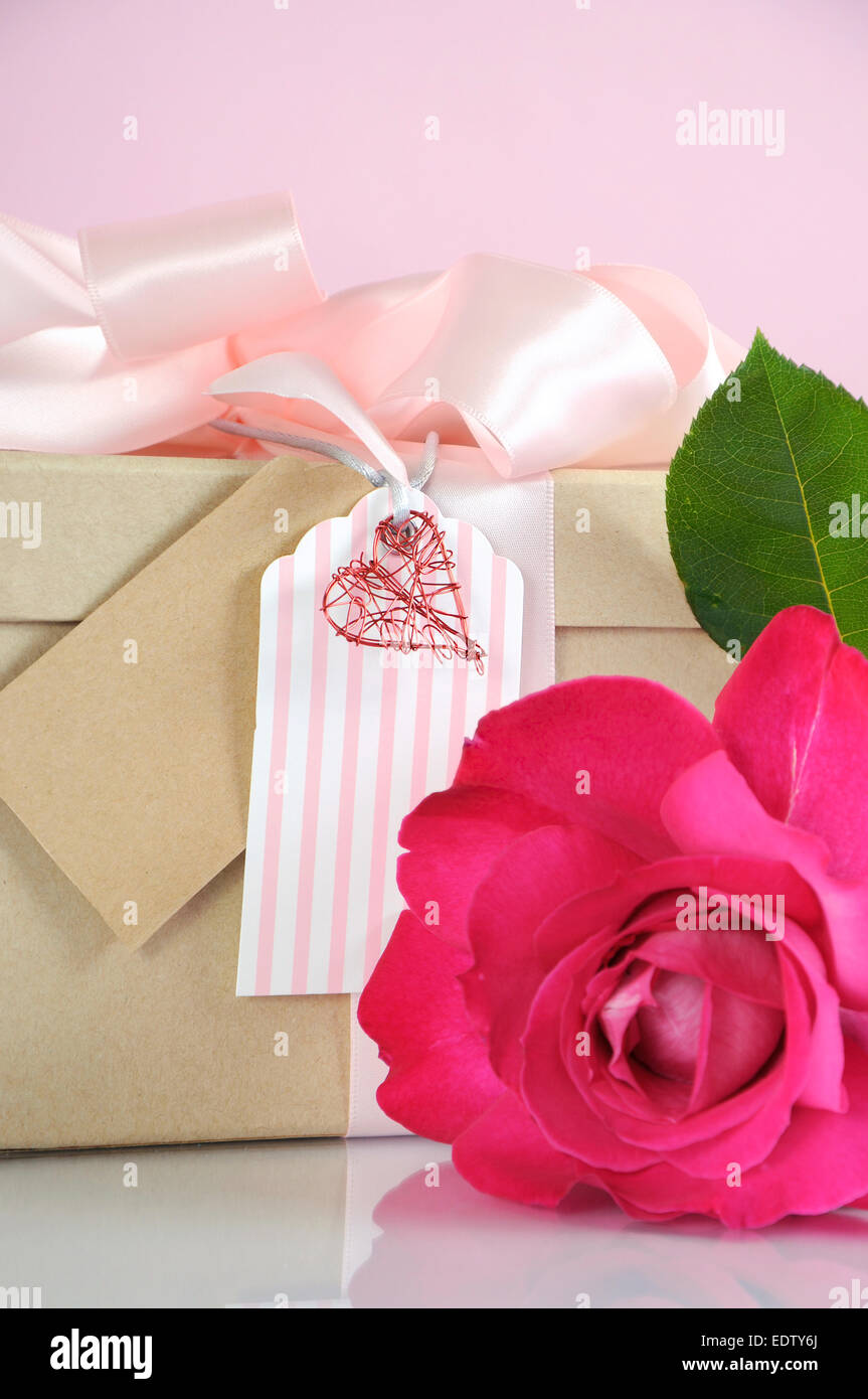 Beautiful classic kraft paper cardboard gift box with pale pink ribbon