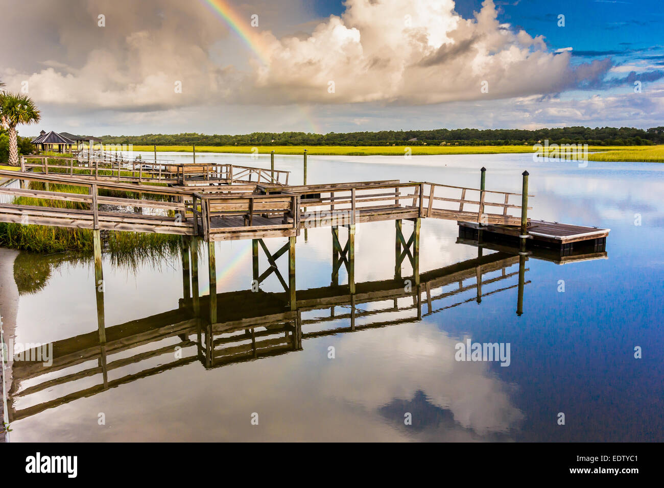 Marshy Inlets After a morning storm, a rainbow reflects on the waters of a marshy ...
