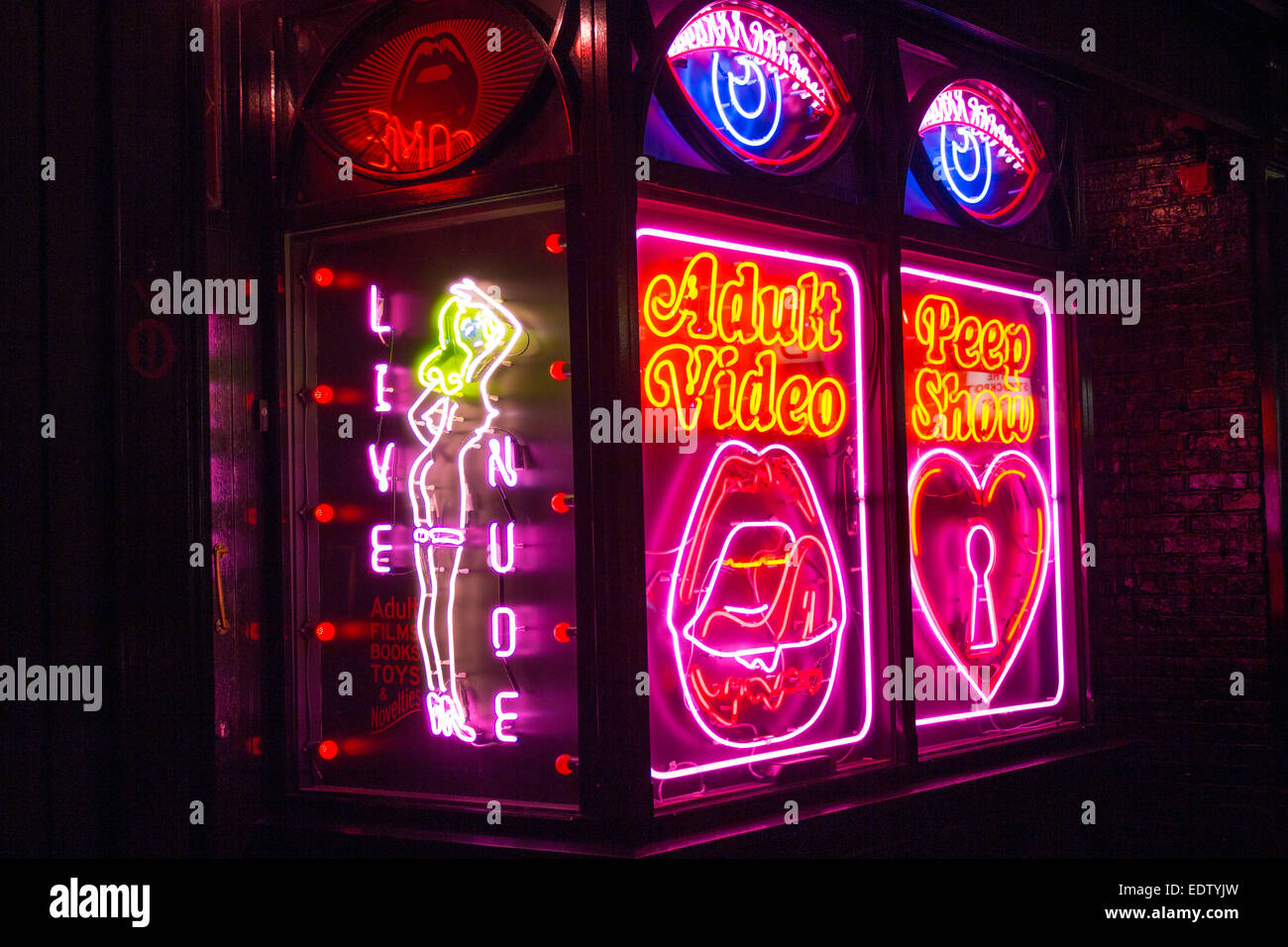 Live Nude Peep Show Adult neon sign with neon outline of naked woman sex show strip tease show girls nudity Soho London England Stock Photo