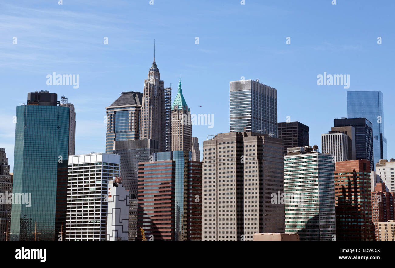 The New York City skyline rises up against a blue sky. Stock Photo