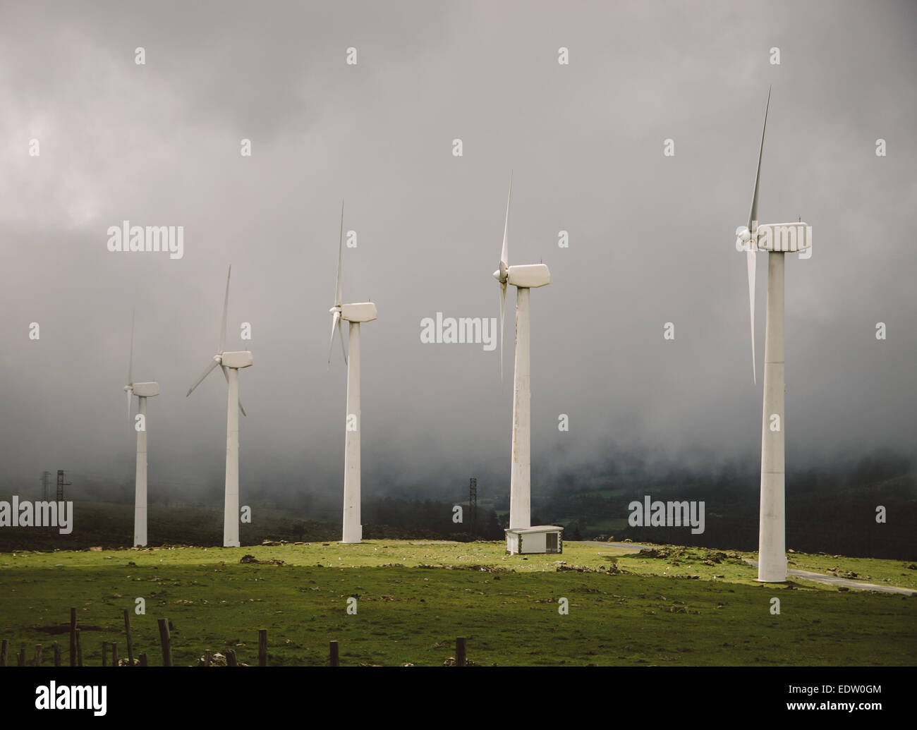 Windmills in the Mist in Galicia, Spain. Stock Photo