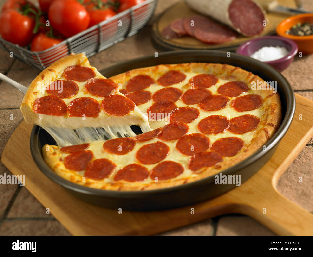 Pepperoni pizza with slice Stock Photo - Alamy
