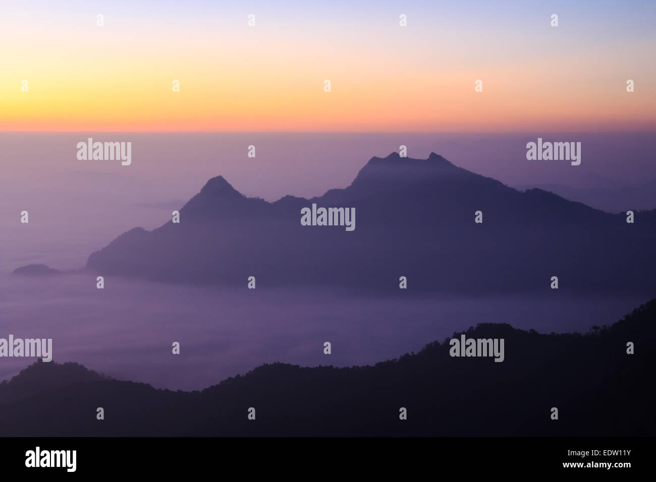 Sea of fog and mountain(silhouette) with sunrise in the morning at Phu Chi Fa ,Chiangrai, ,Thailand Stock Photo
