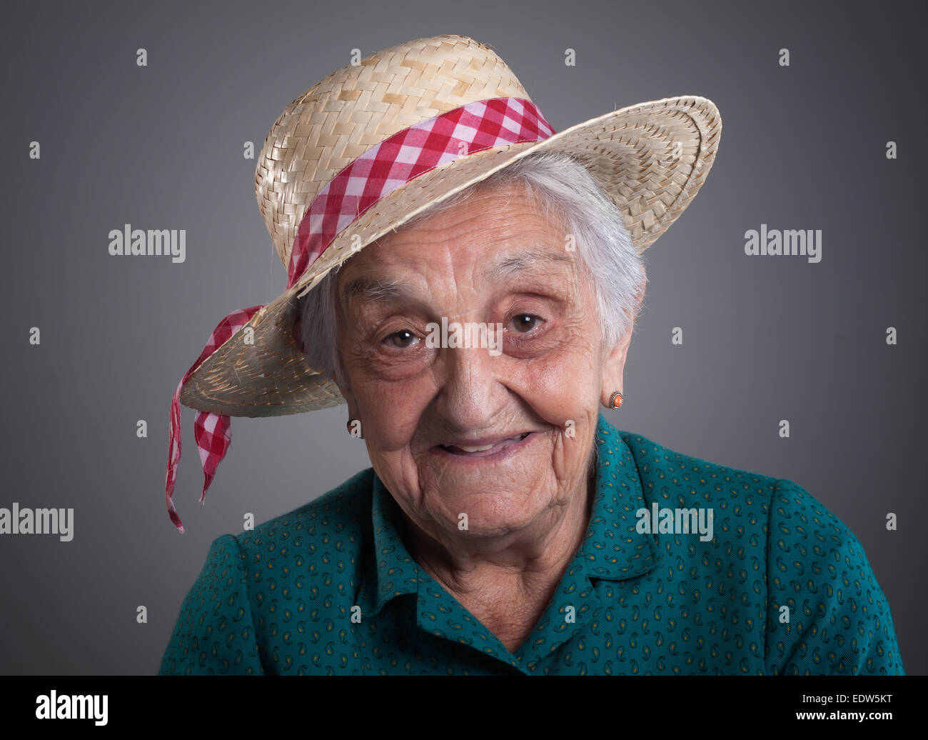 Elderly woman smiling with a hat in her head. Stock Photo