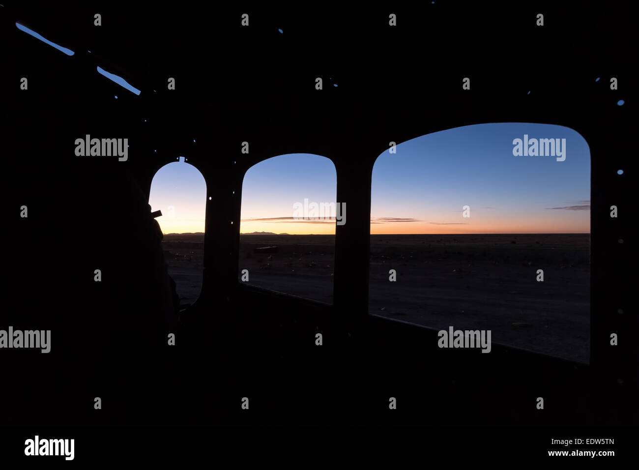 Sunset seen from an old steam locomotive at Uyuni train cemetery, Uyuni, Bolivia, South America Stock Photo