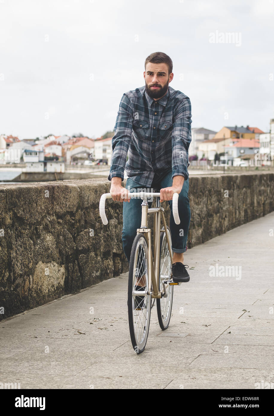 Hipster man riding in a fixie bike in the city. Stock Photo