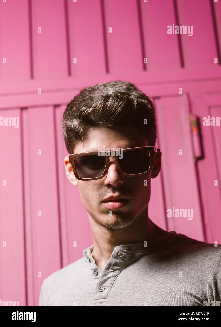 Fashionable man portrait with flash light and fuchsia background Stock Photo