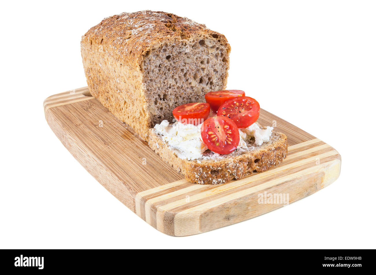 Closeup of slice of wholemeal bread with cottage cheese and cherry tomatoes Stock Photo
