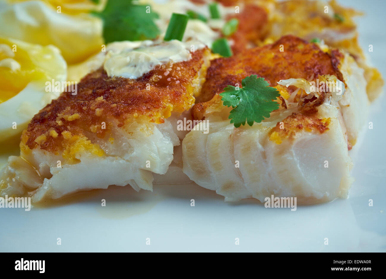Finnan Haddie traditional Scottish breakfast. smoked haddock cooked with egg and sauce Stock Finnan Haddie traditional Scottish breakfast. smoked haddock cooked with egg and sauce Stock