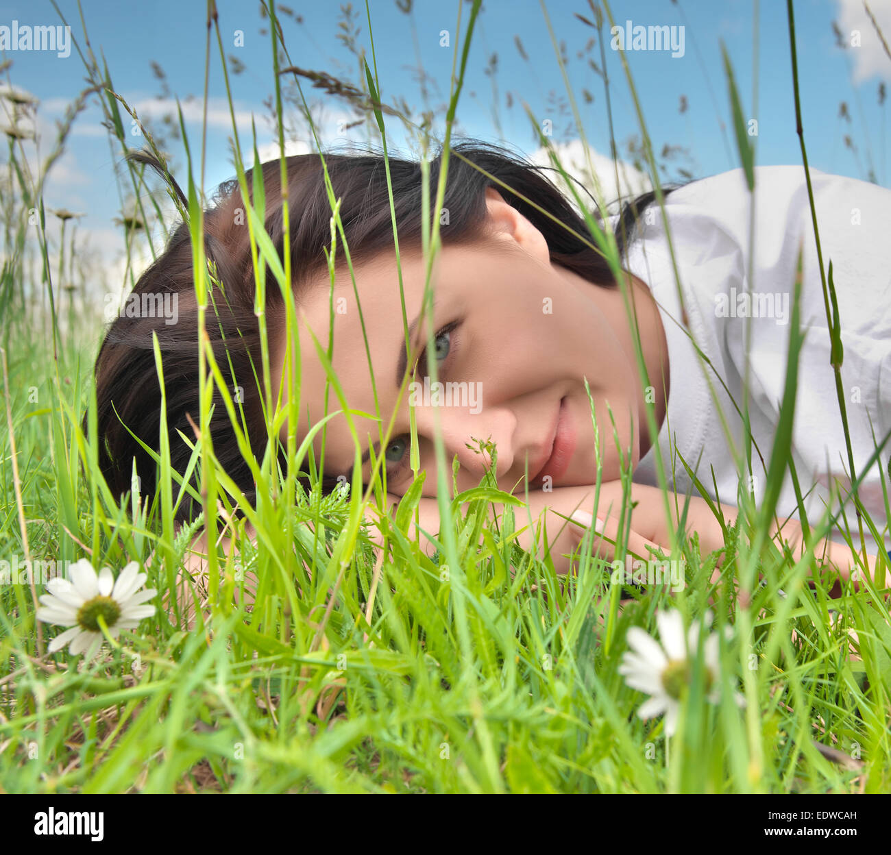 Young pretty girl relaxing on the grass Stock Photo - Alamy