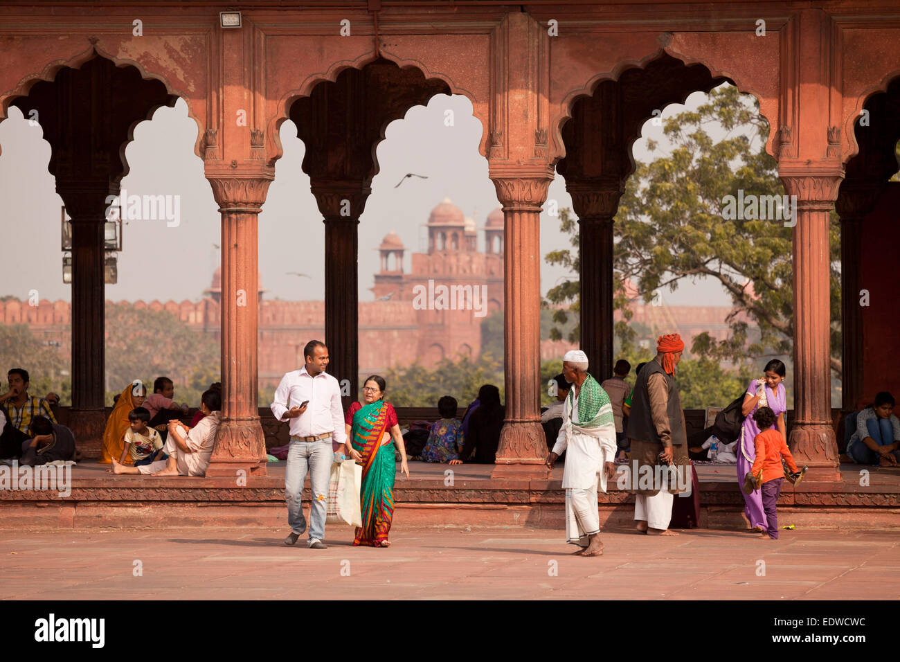 Colonnade in the courtyard of the Friday Mosque Jama Masjid, the Red Fort at the back, Delhi, India, Asia Stock Photo