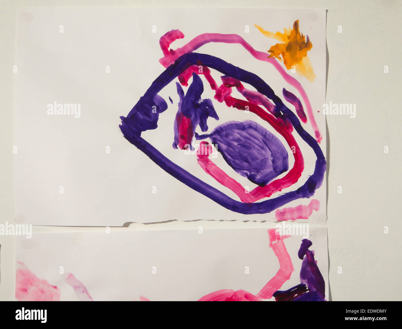 Toddler painting pinned on wall, girls favourite purple and pink colours , abstract circles with yellow sun Stock Photo