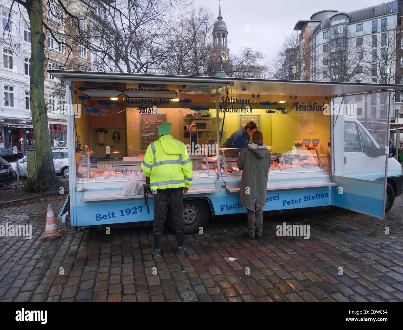 Grossneumarkt square in Hamburg Germany, weekly Saturday morning market, fishmongers stall, vendor and customers Stock Photo