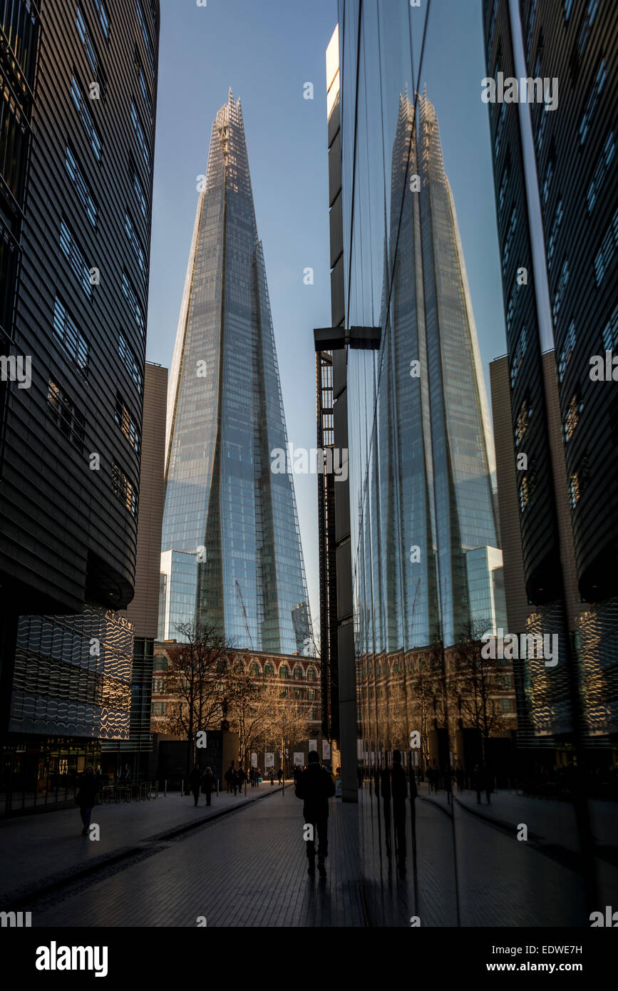 View down More London Place to the Shard which is reflected in the glass buildings of More London Stock Photo