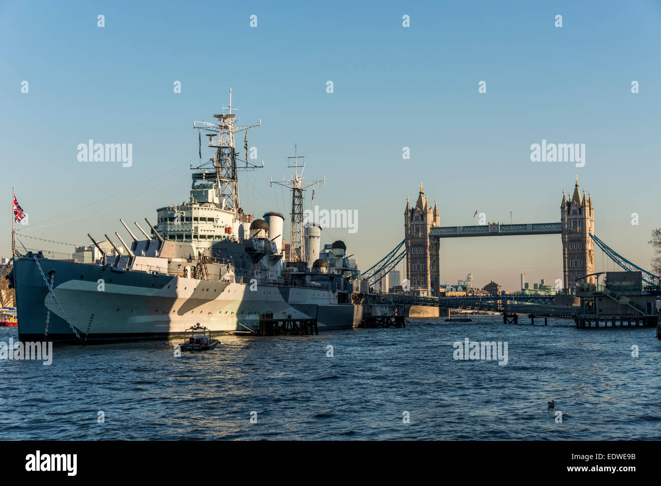 Moored by Tower Bridge, HMS Belfast is a Royal Navy light cruiser and a museum ship in London Stock Photo
