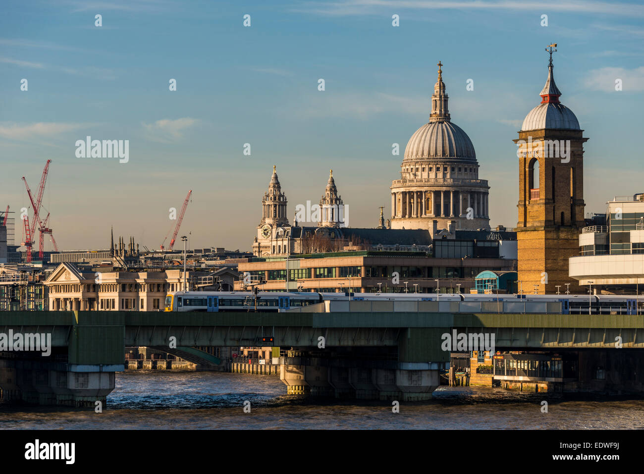 View across the River Thames to cannon Street rail station and St Paul's Cathedral Stock Photo
