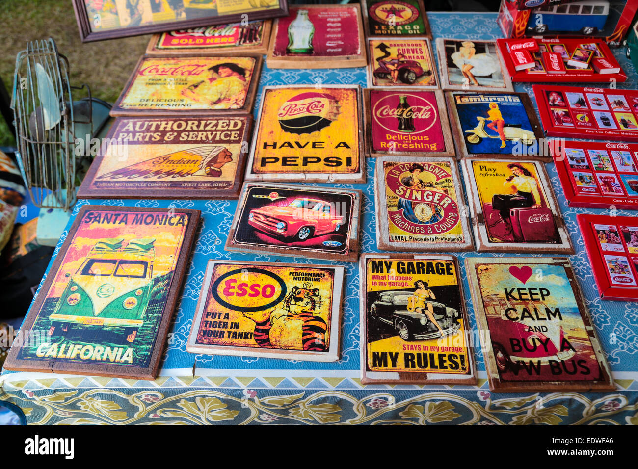 Vintage metal sign panel with various advertisements and promotions