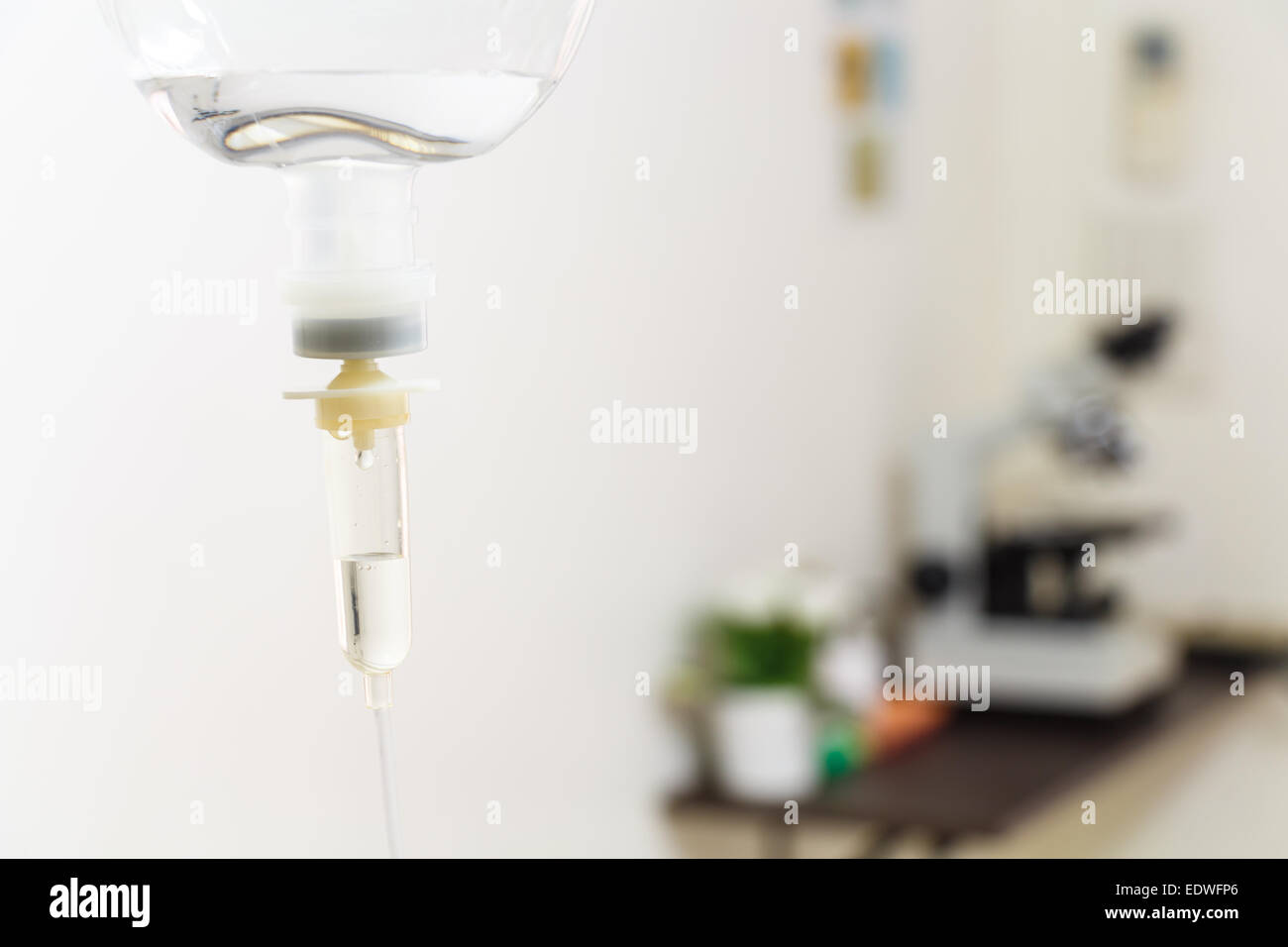 saline solution and microscope in hospital ,Thailand Stock Photo