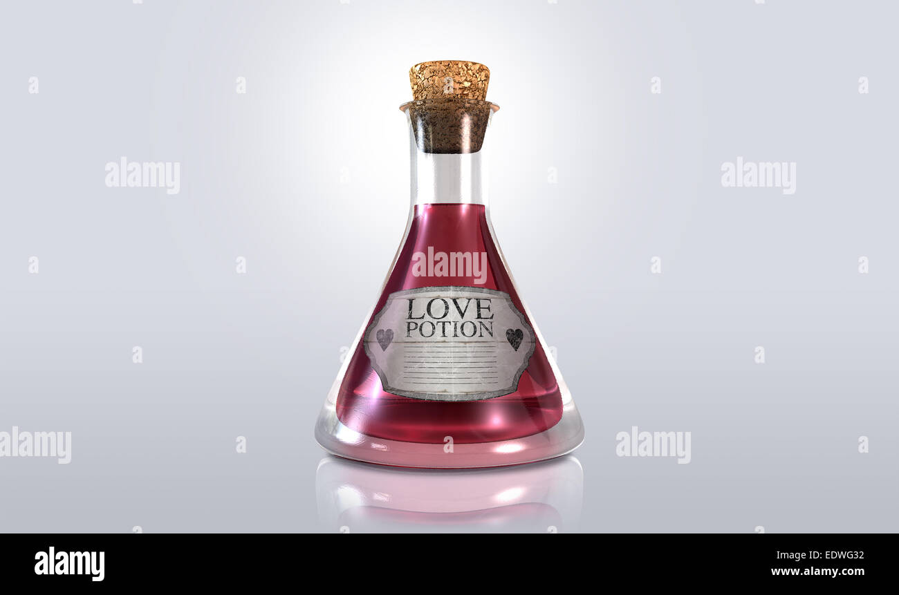 A regular old goblet glass bottle filled with a pink liquid with a label showing it is love potion and sealed with a cork on an Stock Photo