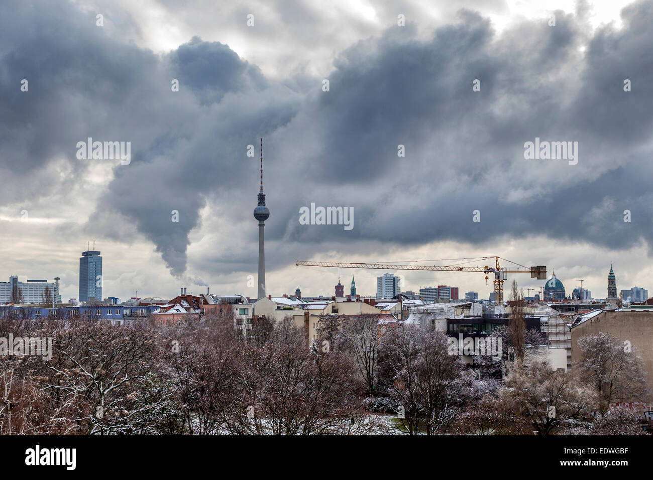 Berlin Skyline with snow covered trees, fernsehturm and dramatic cloudy