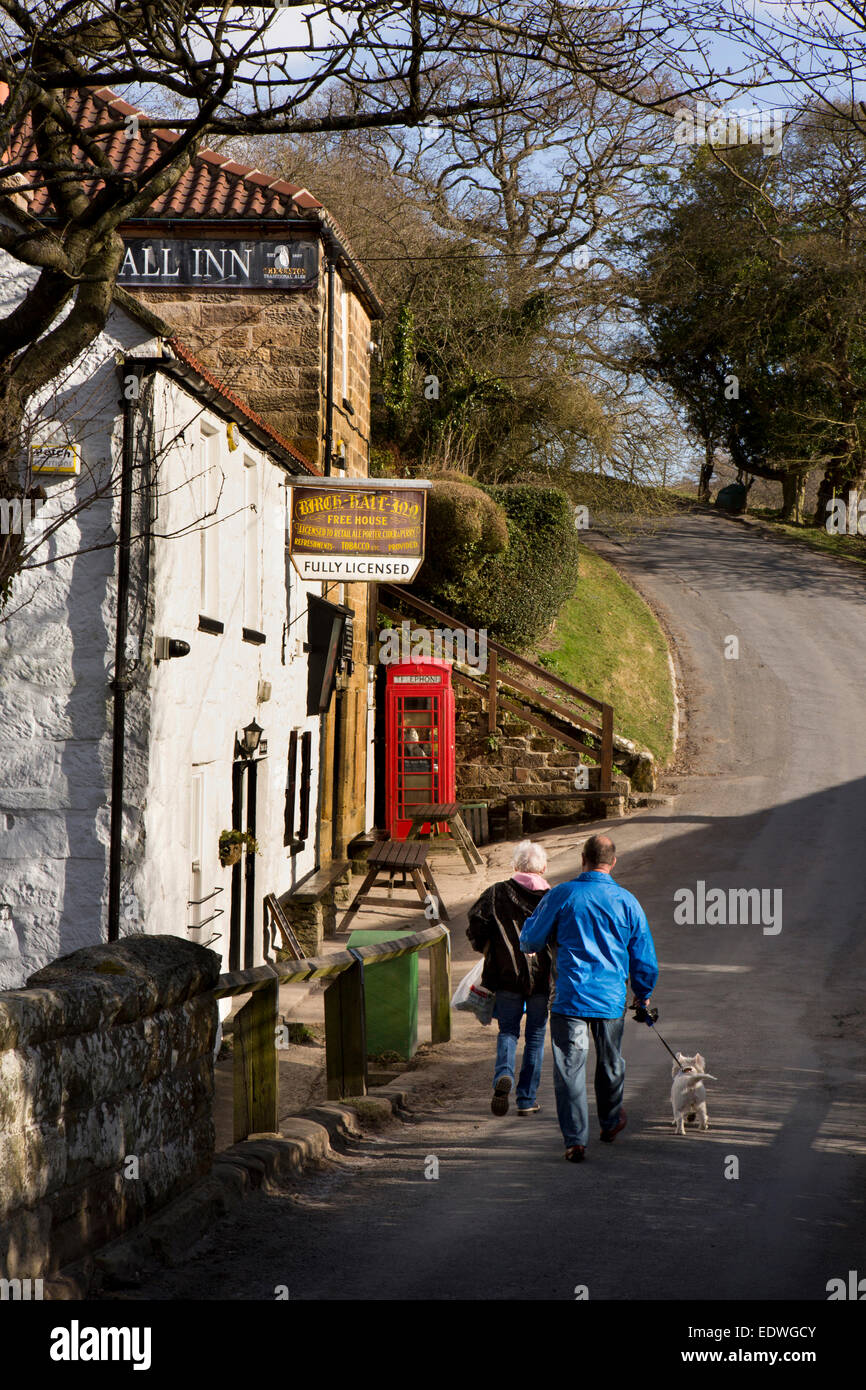 UK, England, Yorkshire, Goathland, Beck Hole, couple walking dog at Birch Hall Inn Stock Photo