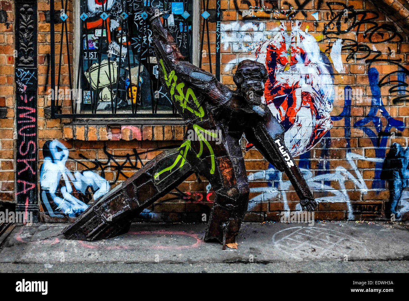 Street art sculpture by Danish street artist TEJN - scrap metal man handcuffed to window bars in Dirksenstrasse,Mitte,Berlin Stock Photo