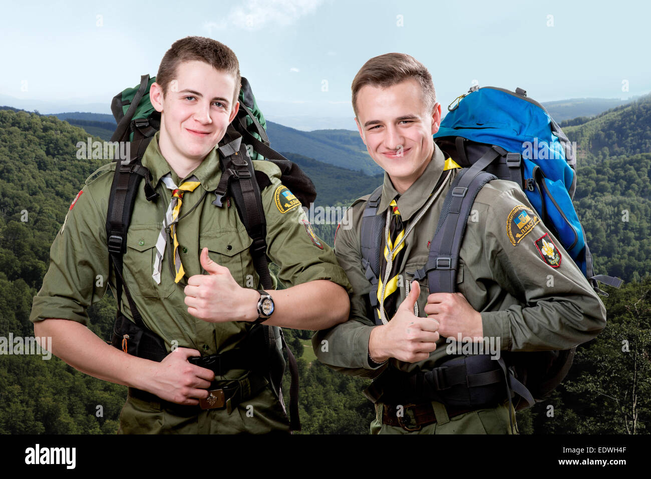 Two young scout boys with sleeping bag and backpack traveling in the