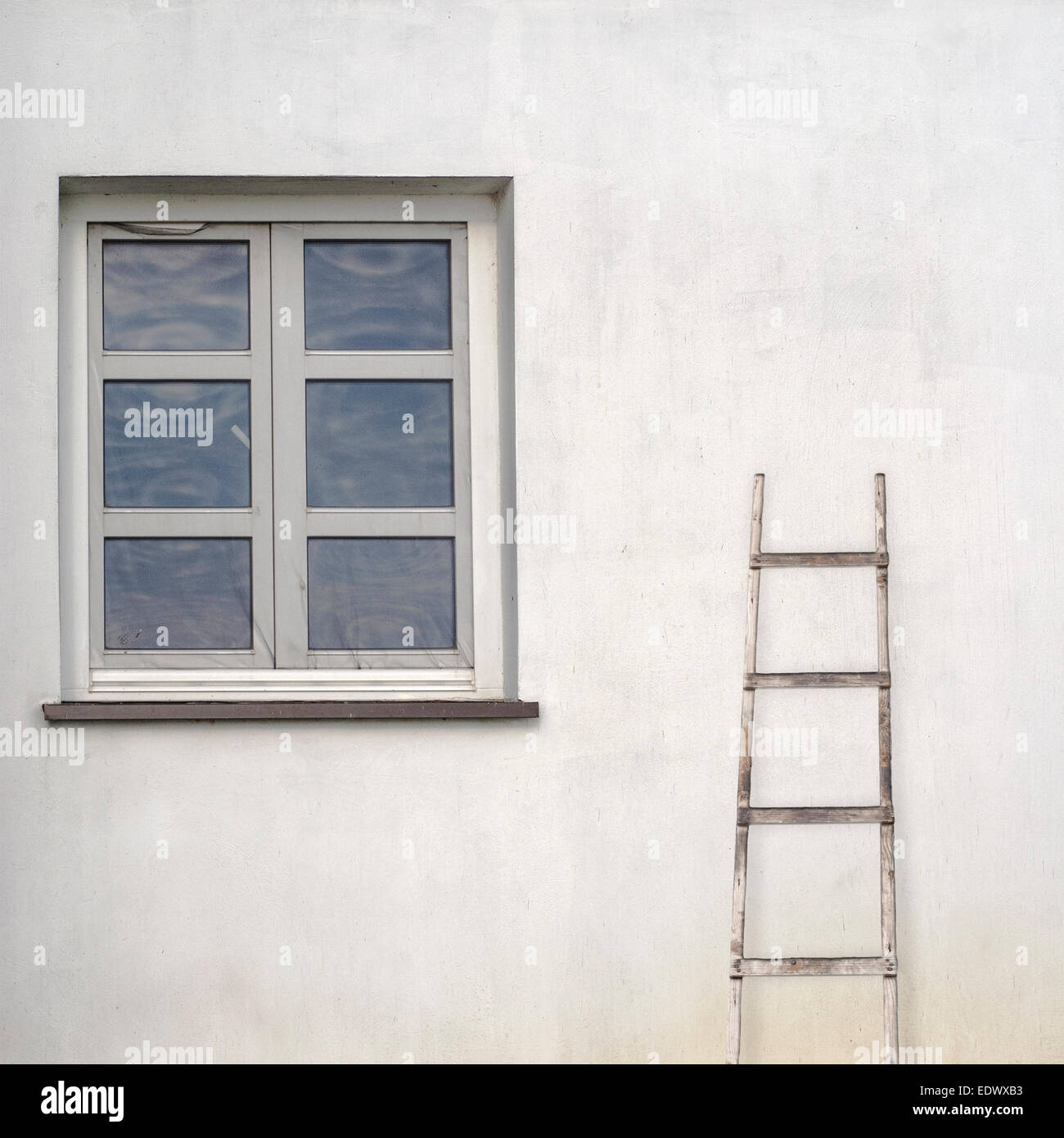stucco wall with window and wooden ladder Stock Photo Alamy