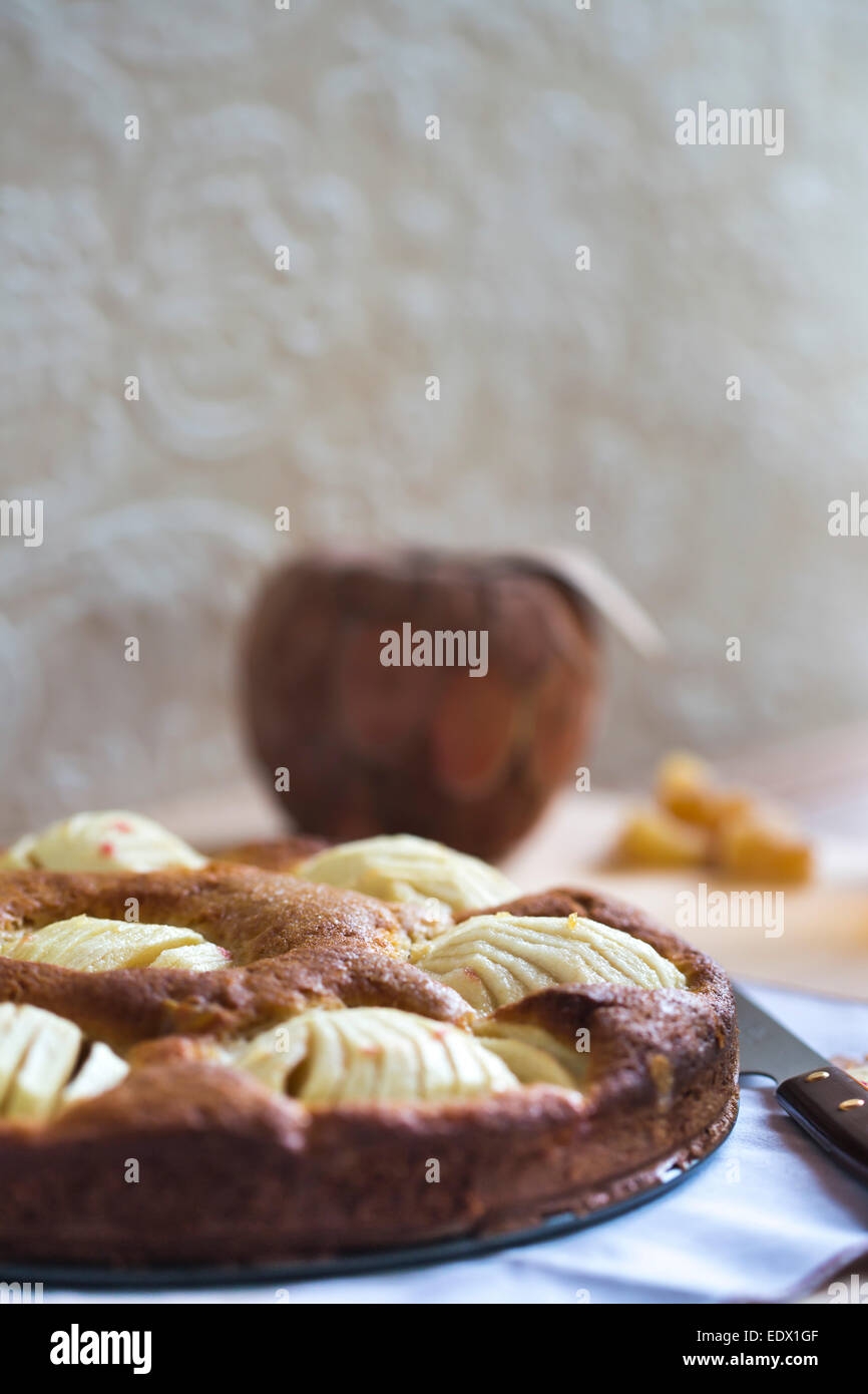 home made apple cake on table with ginger using neutral colour tones Stock Photo