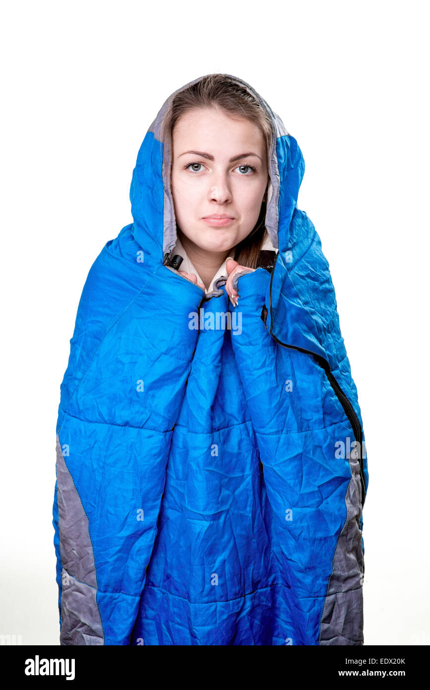 Girl inside the blue sleeping bag isolated on white background Stock Photo Alamy