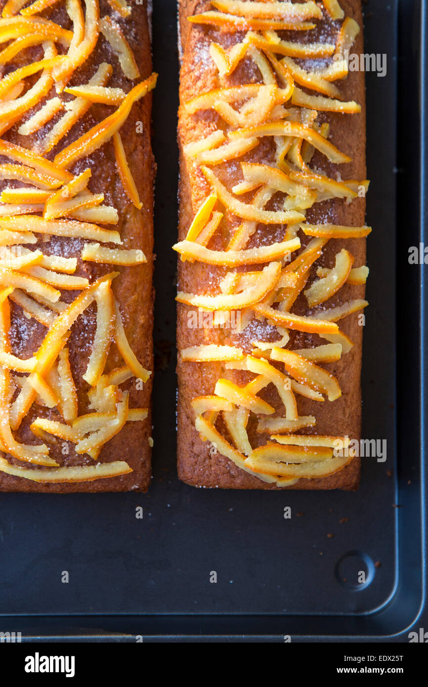 home baked orange cakes on metal tray with home made crystalised orange peel topping Stock Photo