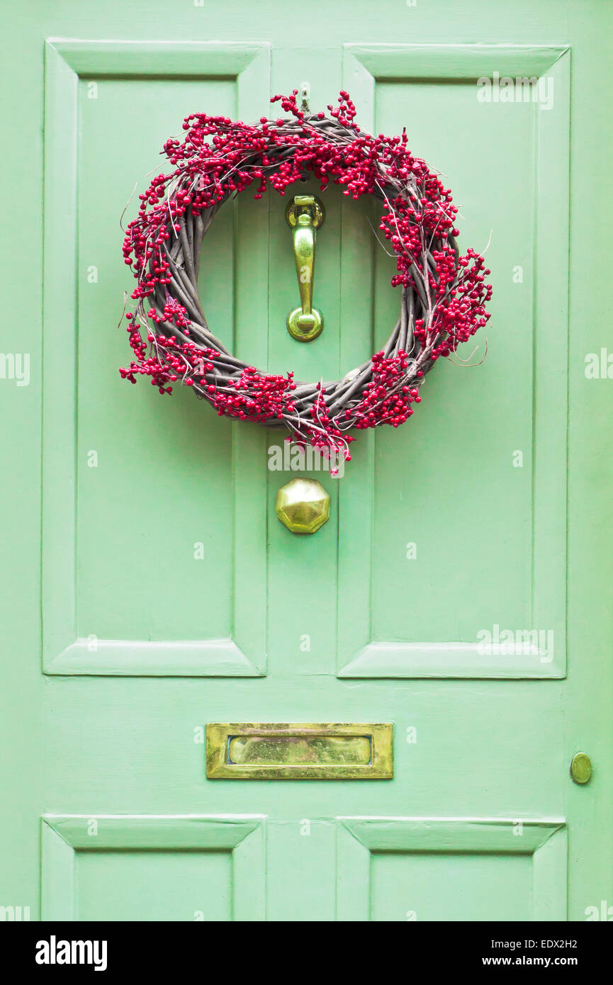 A red berry wreath on a front door Stock Photo
