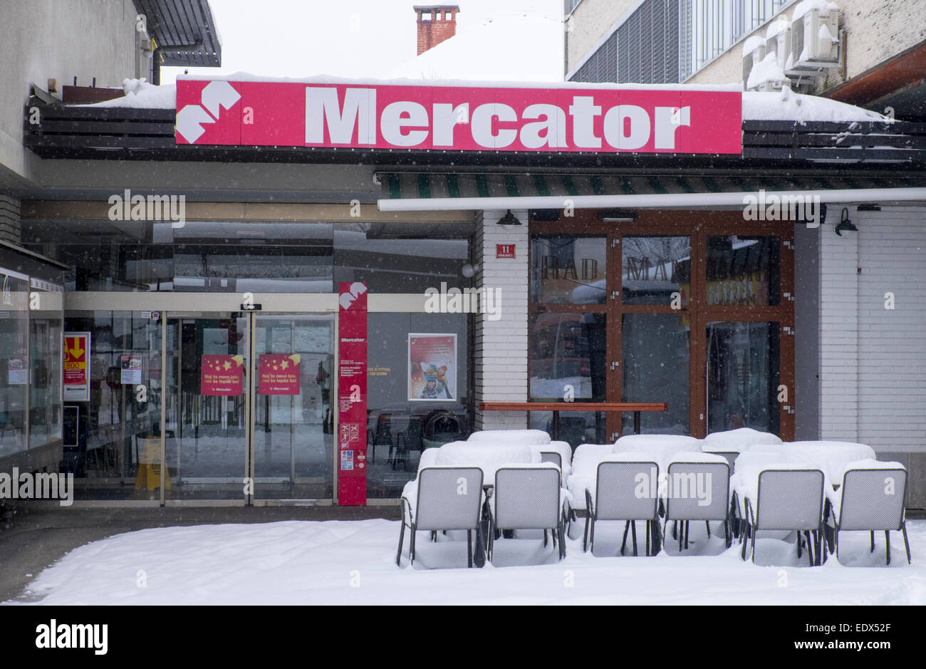 Radovljica branch of Mercator supermarket covered in snow in Stock ...