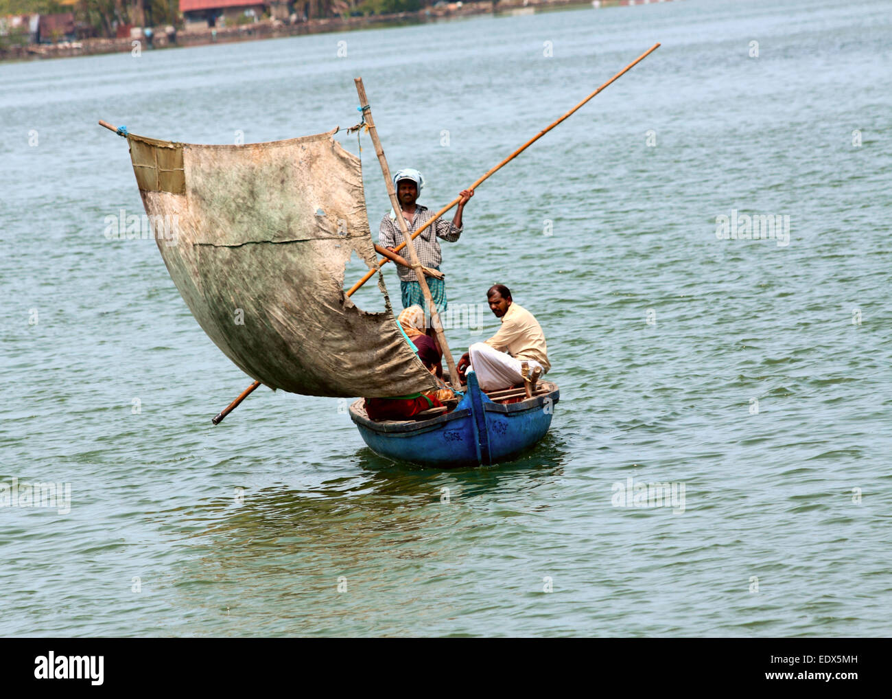 Fisherman's family sailing on a little boat in India. Stock Photo