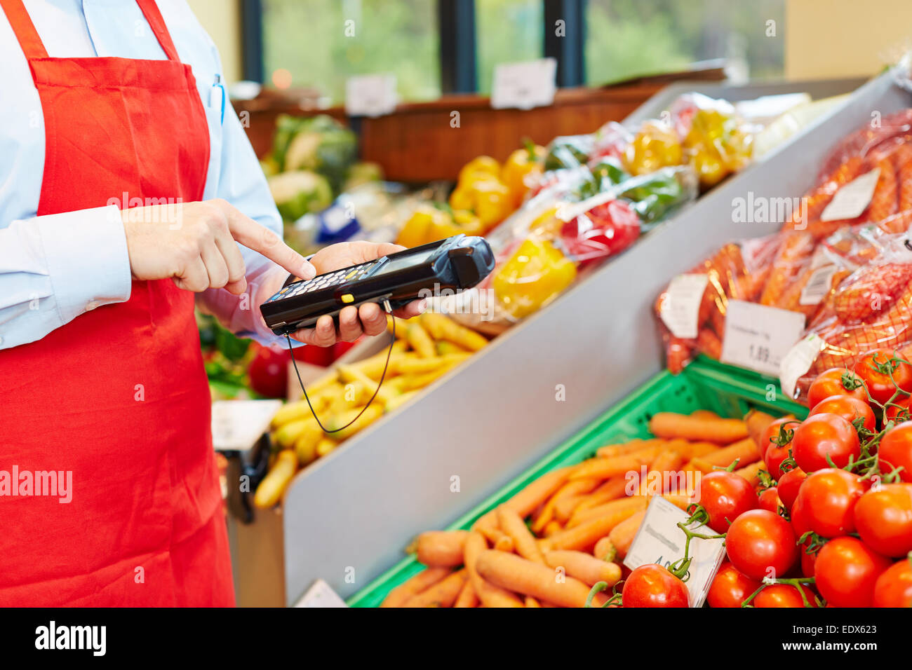 Hand of salesperson using mobile data acquisition terminal in a supermarket Stock Photo