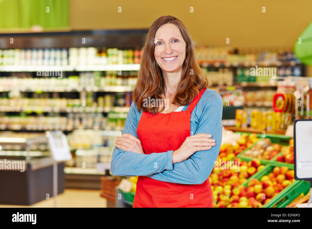 Portrait of smiling female store manager in a supermarket with her arms crossed Stock Photo