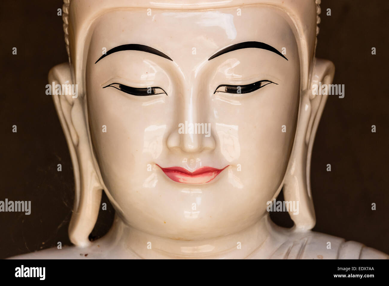 Porcelain statue of Buddha - Heat shot. Stock Photo