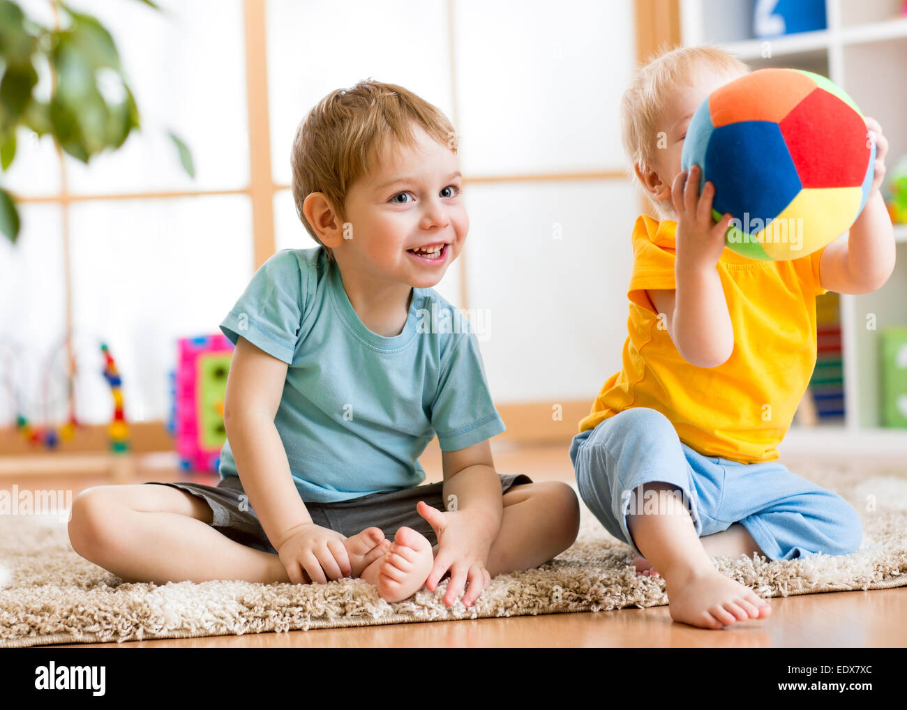 children play with ball indoor Stock Photo