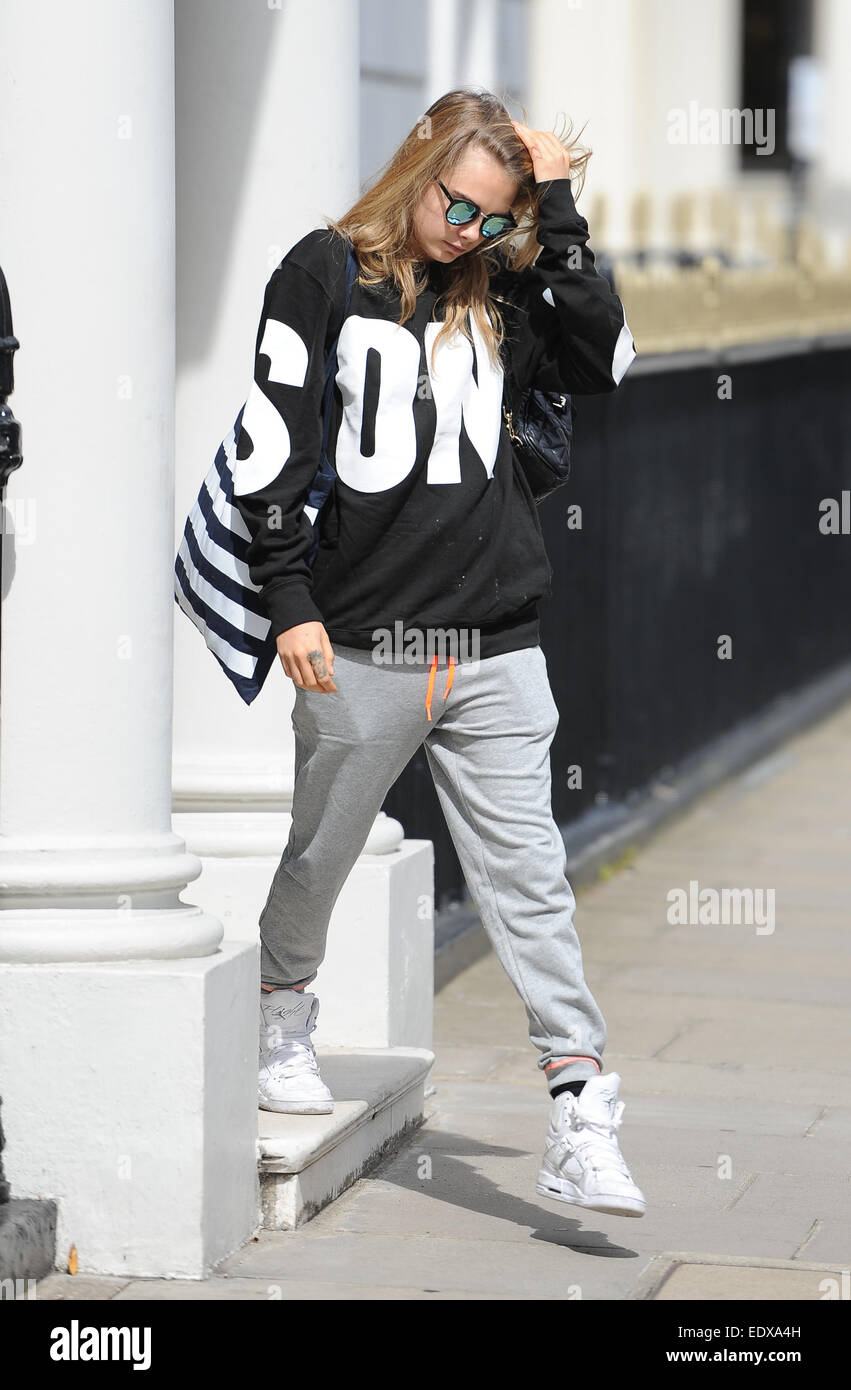 Cara Delevingne leaving home wearing grey tracksuit bottoms, high top  trainers, baggy sweatshirt and sunglasses. Featuring: Cara Delevingne  Where: London, United Kingdom When: 09 Jul 2014 Stock Photo - Alamy