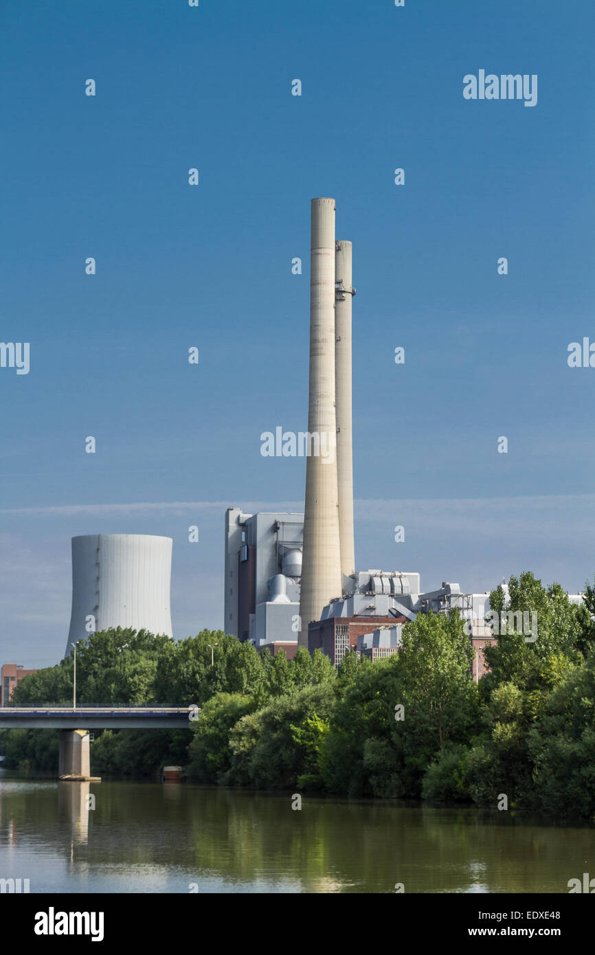 german coal-fired power station at the river Neckar with blue sky and bridge. Stock Photo