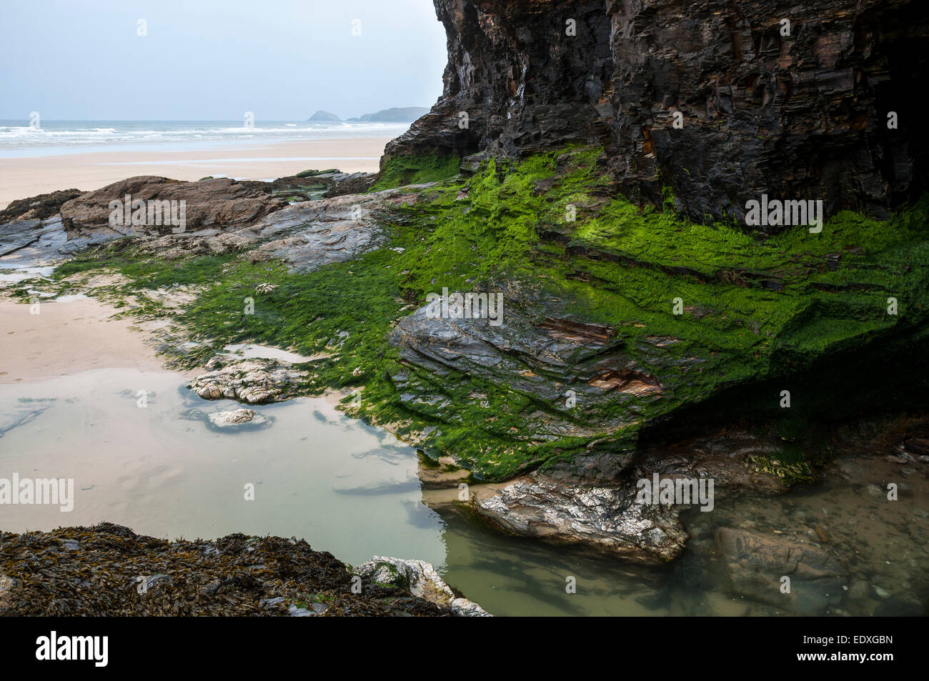 Interesting geology in the rocks at Perranporth beach in Cornwall. View from out of a cave. Stock Photo