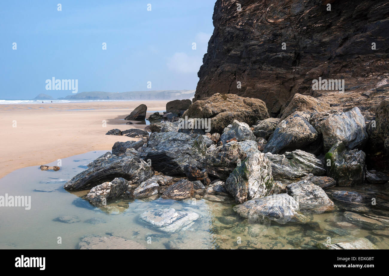 Interesting geology in the rocks at Perranporth beach in Cornwall. View along the sandy beach toward the headland. Stock Photo