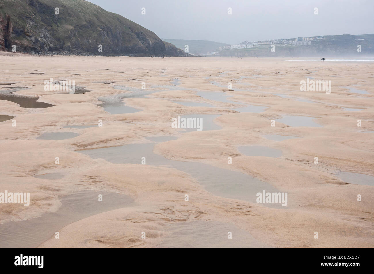 Wide expanse of sand and water at Perranporth beach in Cornwall. Looking back towards the cliffs and the village. Stock Photo