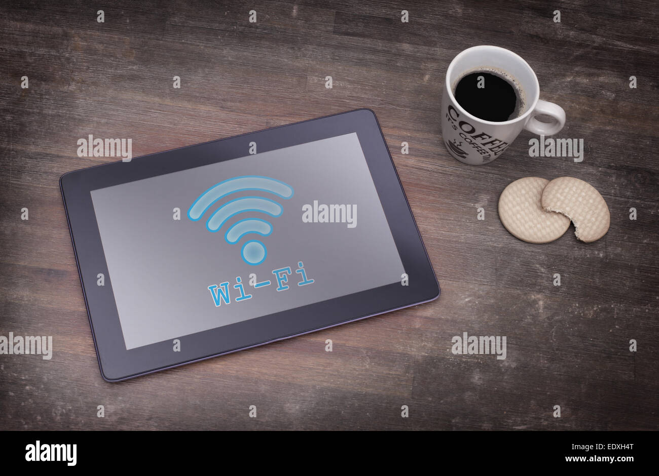 Tablet with Wi-Fi connection on a wooden desk,vintage setting Stock Photo