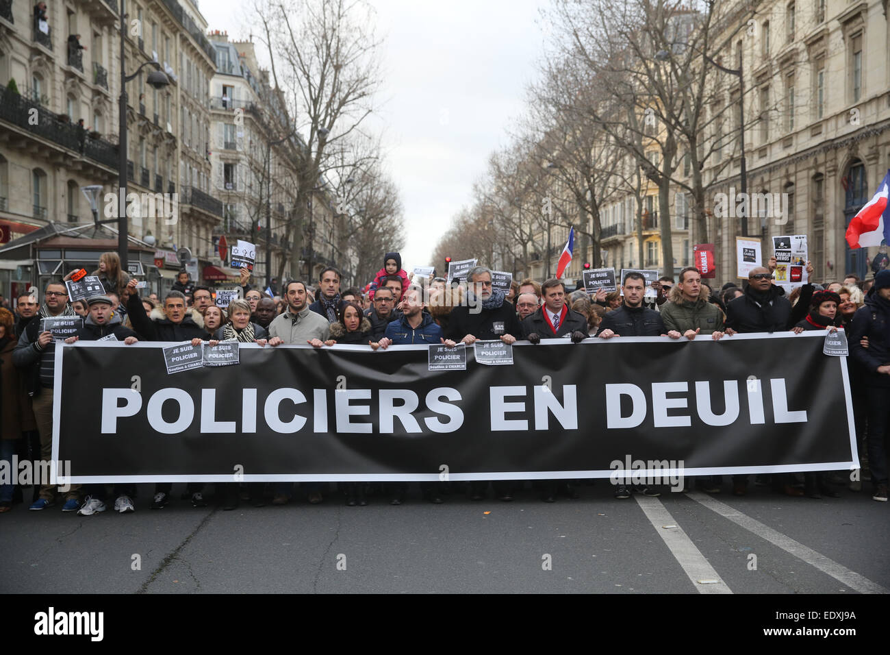 People hold up a sign which reads 'Policiers en deuil' (Police in mourning) as they gather for a march against terrorism in Paris, France on 11 January 2015. Several European heads of state joined a manifestation to express their solidarity following the recent terrorist attacks in France and to commemorate the victims of the attack on the French Charlie Hebdo satirical magazine and a kosher supermarket in Paris. Photo: Kay Nietfeld/dpa Stock Photo