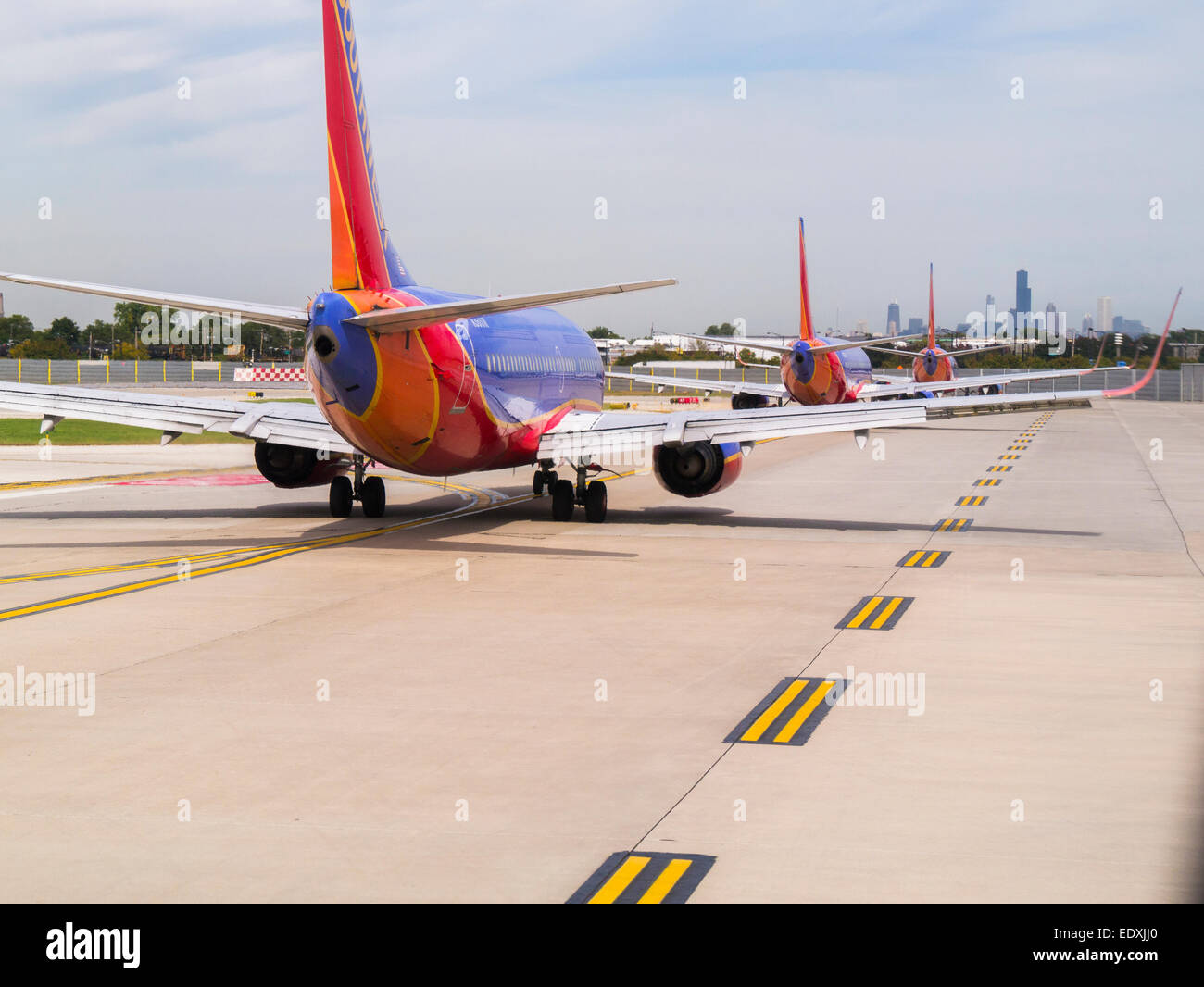 Passenger jets lined up on taxiway for takeoff at Chicago Midway Airport Stock Photo