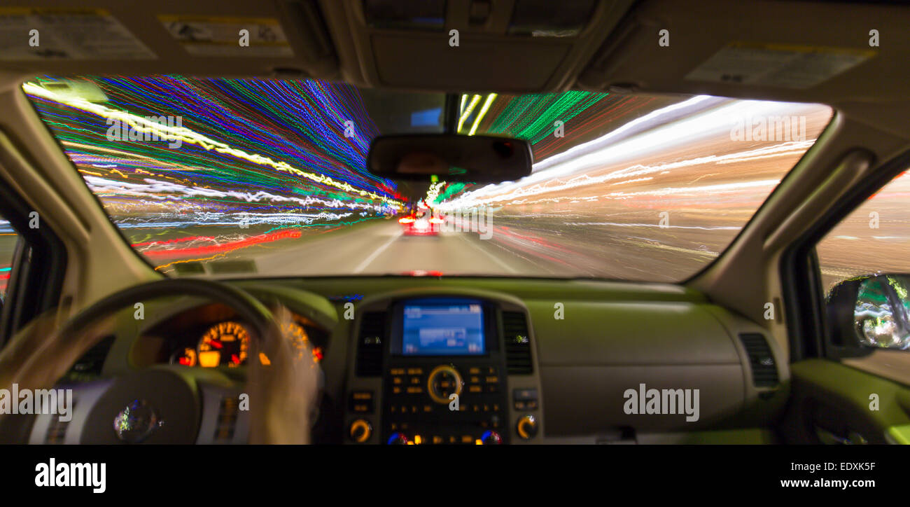 Night view out windshield of car while driving with blurred roadway and lights Stock Photo Alamy